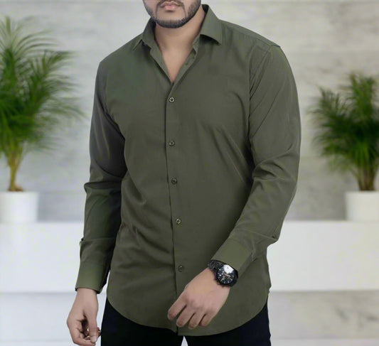 Man wearing a green shirt against a plain background