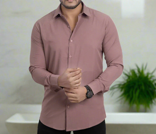 Man wearing a mauve button-up shirt on a light gray background