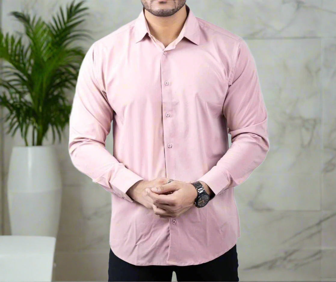 Person wearing a light pink dress shirt on a white background