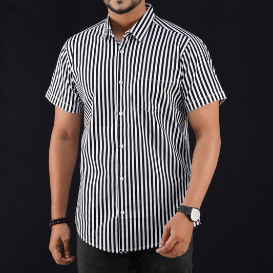 Man wearing a black and white striped shirt against a black background